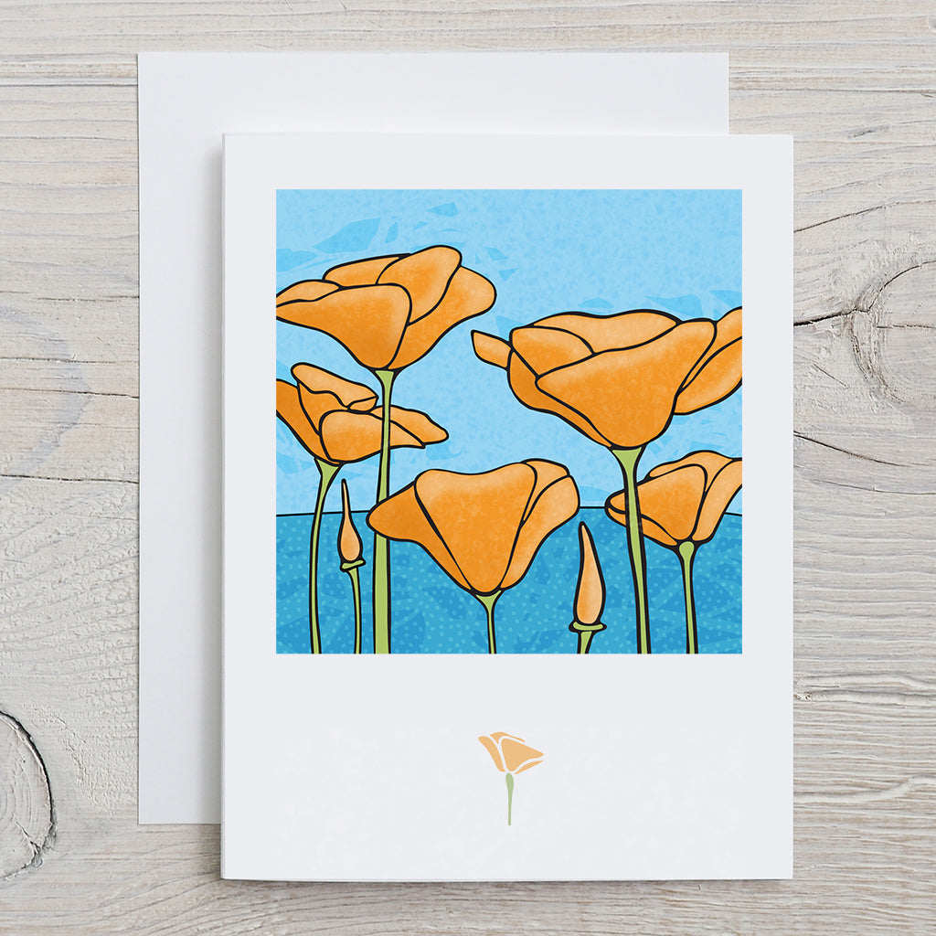 Front of KatCo Creations greeting card with orange poppies design with ocean landscape background